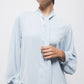 Blusa tinta unita con fiocco al collo