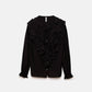 Blusa nera con volant e laccio al collo