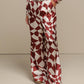 Pantaloni a palazzo con stampa geometrica color ruggine