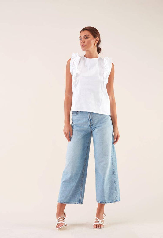 Blusa bianca con volant e fiocco sul retro