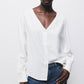 Blusa con paillettes e scollo a V