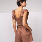 Top crop aderente con volant