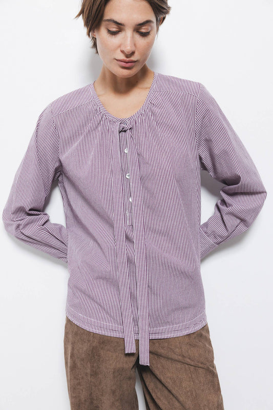 Blusa a quadretti con fiocco e bottoni a contrasto