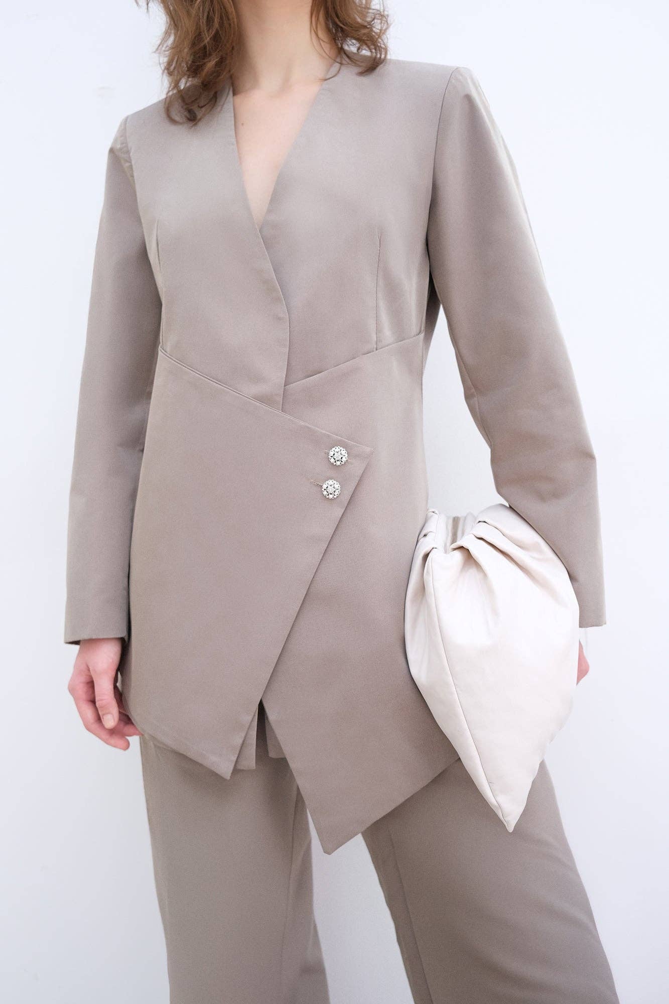 Completo elegante con blazer asimmetrico e pantaloni palazzo con bottoni gioiello