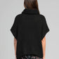 Pull oversize nero stile poncho con collo alto