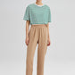 Pantaloni in crepe beige a vita elastica