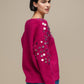 Maglione in maglia con paillettes sulle maniche
