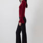 Blusa in maglia con maniche a balze in chiffon trasparente