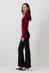 Blusa in maglia con maniche a balze in chiffon trasparente