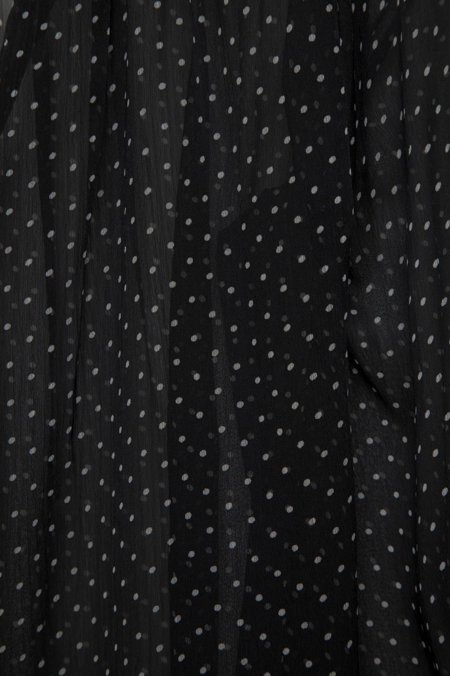 Blusa a pois semitrasparente con scollo a V
