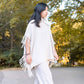 Poncho in maglia con frange e collo alto