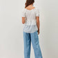 Blusa a balze bicolor con scollo elasticizzato