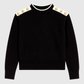 Maglione nero con collo alto e bottoni gioiello sulle spalle
