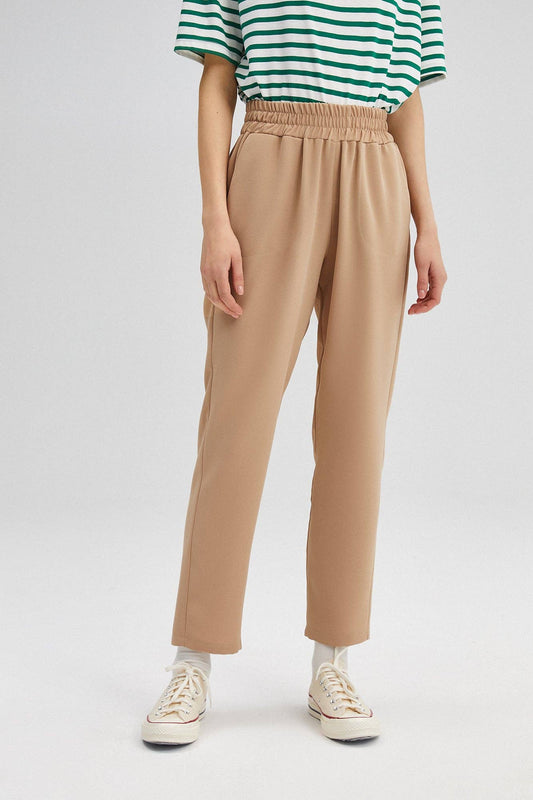 Pantaloni in crepe beige a vita elastica