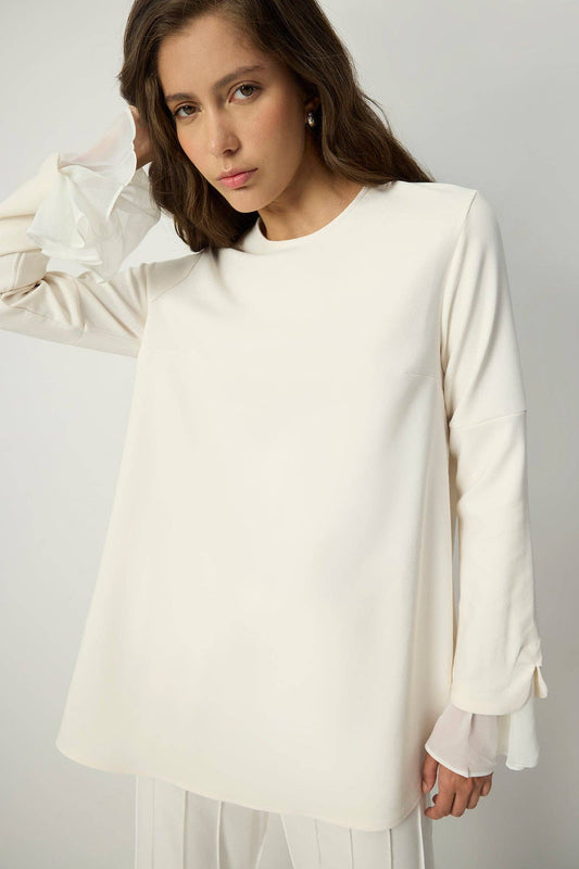 Tunica in crêpe con polsini in chiffon trasparente