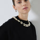 Maglione nero in maglia con perle applicate