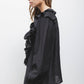 Blusa nera con volant e laccio al collo