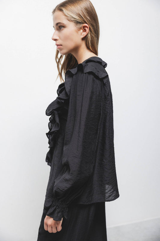 Blusa nera con volant e laccio al collo