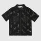 Camicia in pizzo nero con colletto e maniche corte