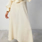 Set coordinato crema con blusa peplo e gonna maxi