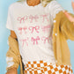 T-shirt grafica con fiocchi rosa