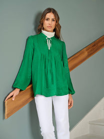 Tunica jacquard verde con fiocco al collo