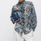 Blusa stampata con fiocco al collo