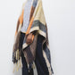 Poncho a quadri con frange