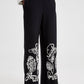 Pantaloni in crêpe neri con ricami