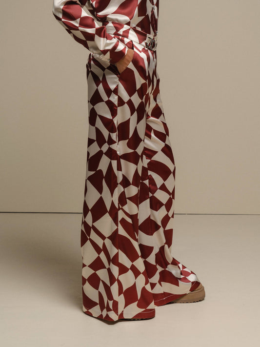 Pantaloni a palazzo con stampa geometrica color ruggine