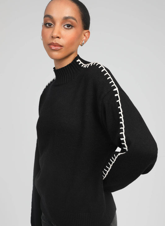 Maglione dolcevita nero Nissya con cuciture a contrasto
