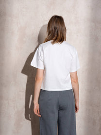 T-shirt bianca con applicazione lucida