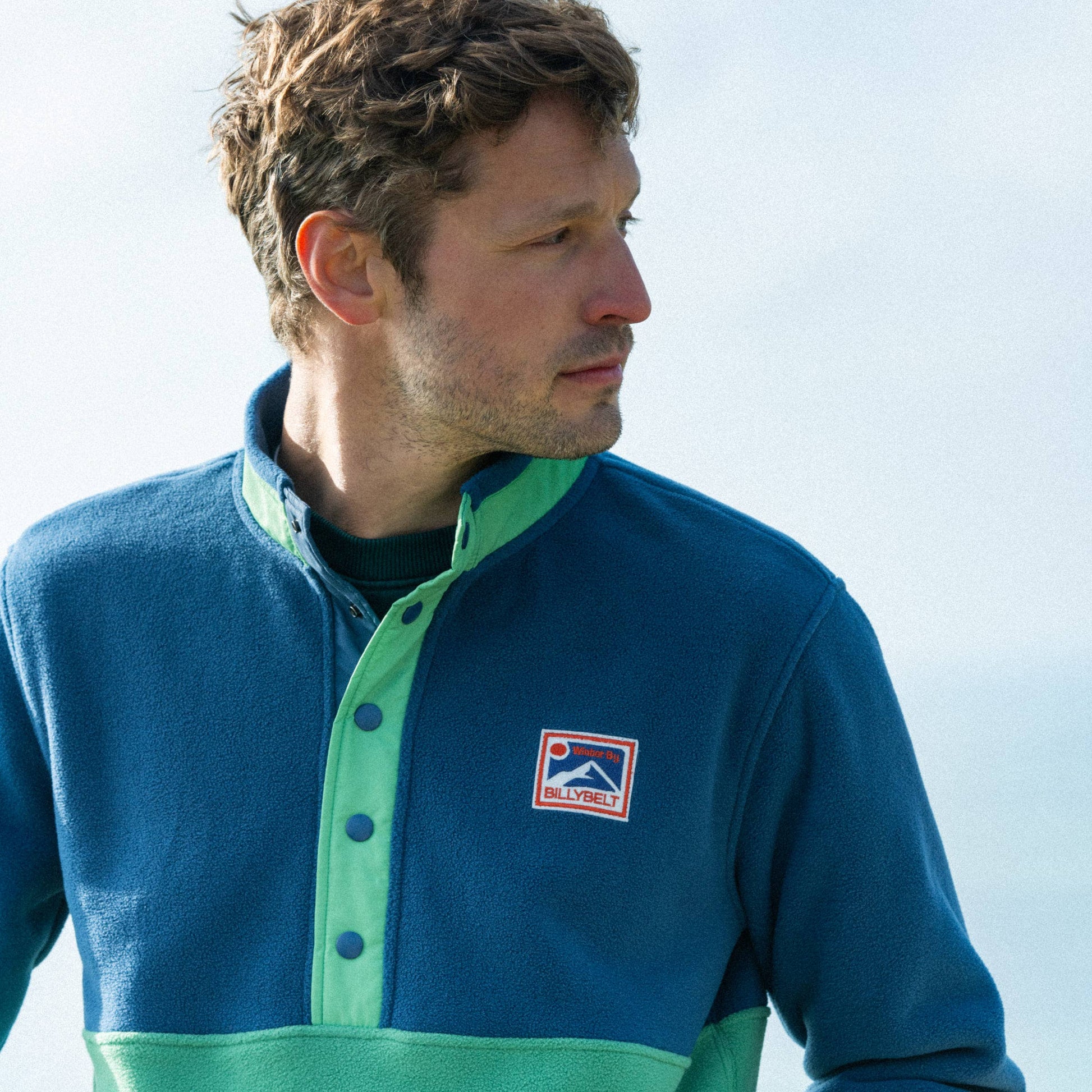 Felpa in pile bicolore blu navy e verde con bottoni