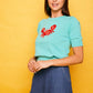 Top in maglia verde con ricamo granchio