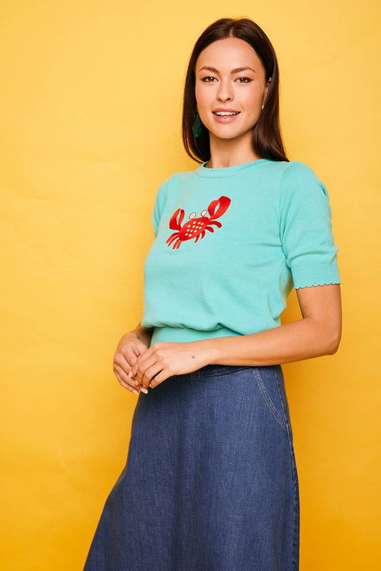 Top in maglia verde con ricamo granchio