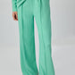 Completo in crepe verde menta con tunica plissettata e pantaloni a gamba larga