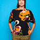 Camicia nera a maniche corte con stampa floreale e bottoni sul retro