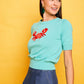 Top in maglia verde con ricamo granchio