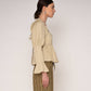Blusa beige con volant e schiena aperta