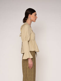 Blusa beige con volant e schiena aperta