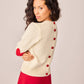 Maglione bianco in maglia con toppe a cuore e bottoni sul retro