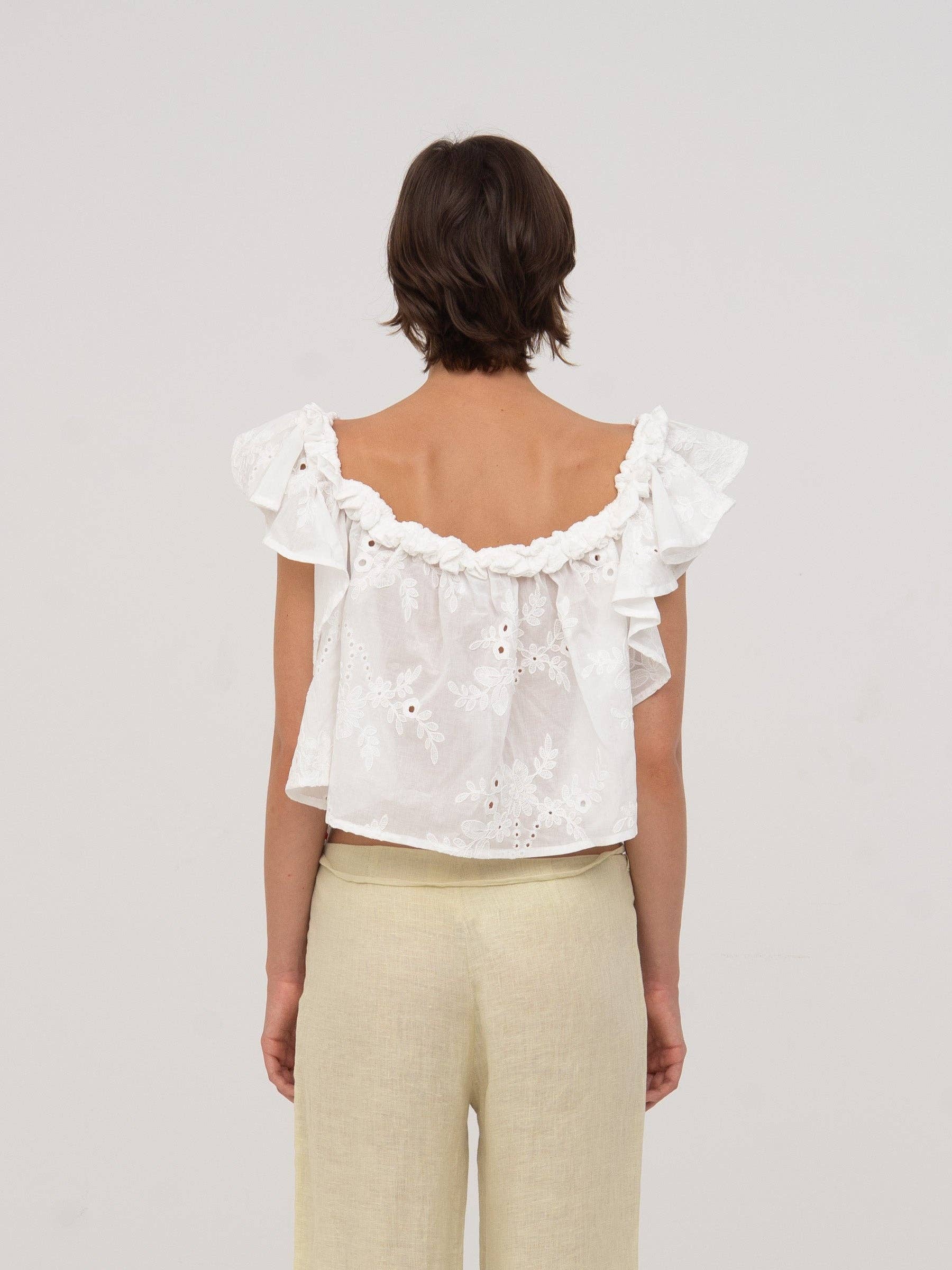 Top bianco Lux con volant e ricami