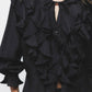 Blusa nera con volant e laccio al collo