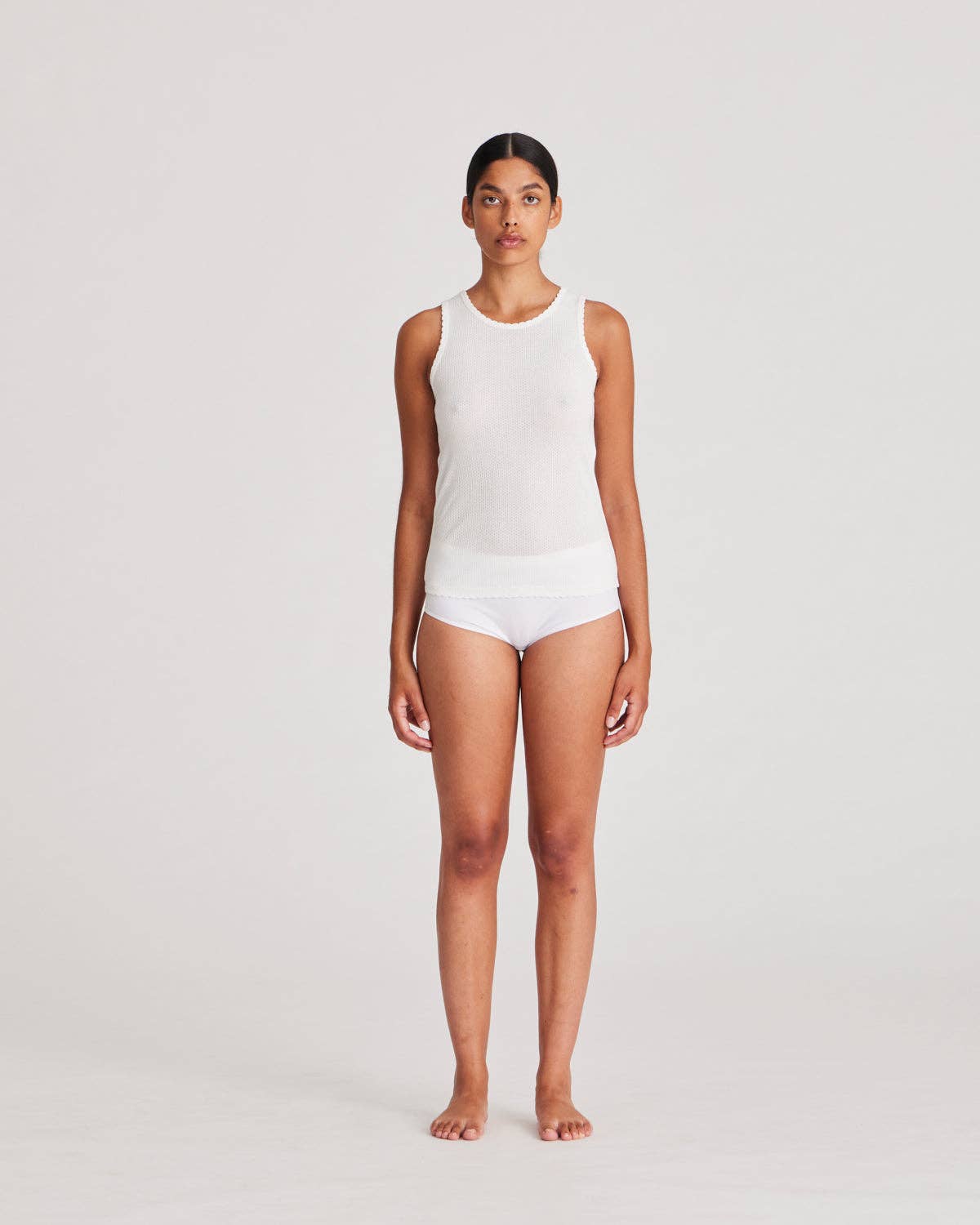 Top in cotone biologico con dettagli in pizzo