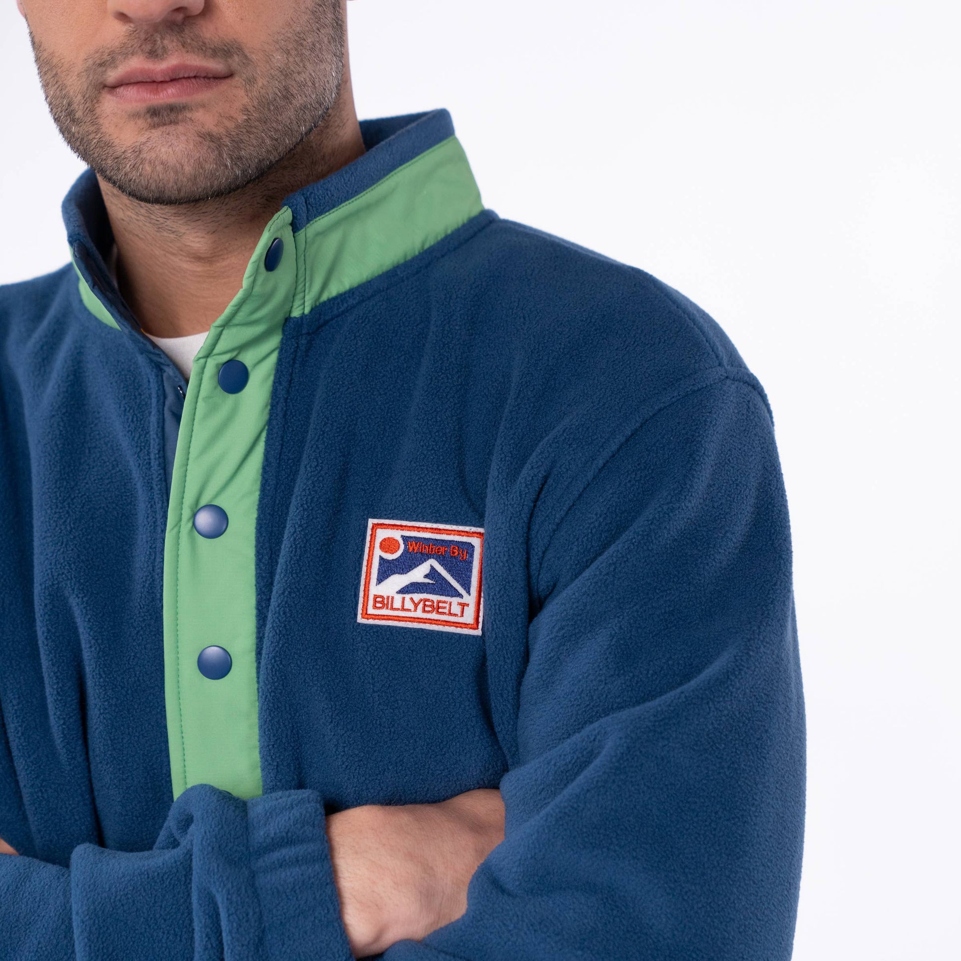 Felpa in pile bicolore blu navy e verde con bottoni