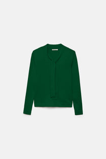 Maglione a maglia rasata con scollo a V e fiocco