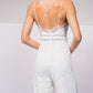 Tuta intera in pizzo con scollo a V e spalline incrociate