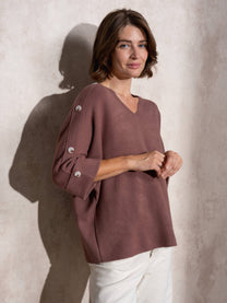 Maglia ampia in maglia con bottoni sulle maniche