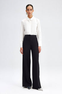 Pantaloni palazzo neri in crepe con piping a contrasto