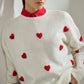 Maglione in maglia ecru con cuori ricamati